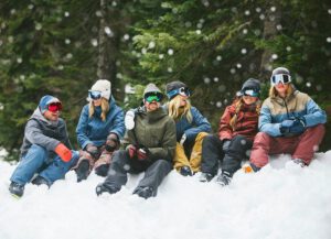 Six people in the snow sitting down