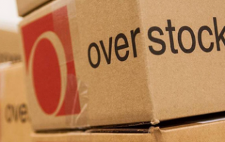 Stack of cardboard boxes with red Overstock logo