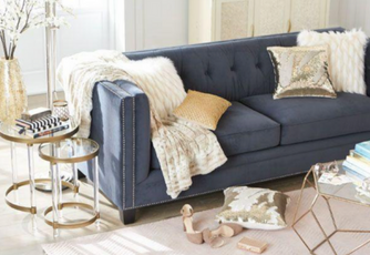 Modern navy blue couch with white and gold pillows