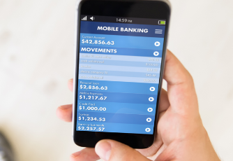 Person holding a smartphone while using a mobile banking app