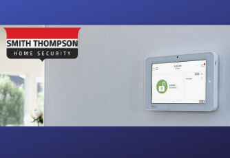 Smith Thompson Home Security logo beside a modern touchscreen security system
