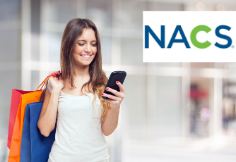 woman smiling at phone while shopping