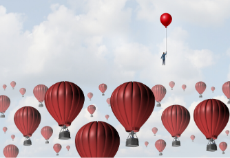 Businessman holding a red balloon and floating in the sky above hot air balloons