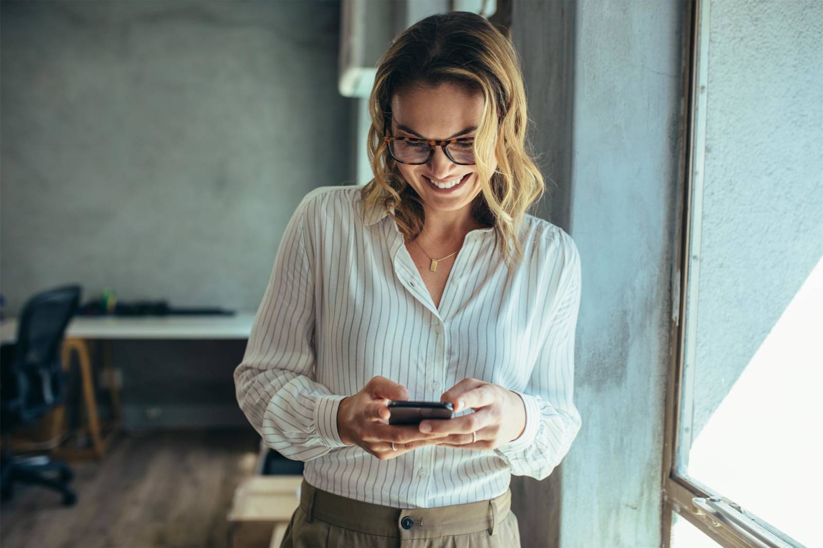 Business professional woman holding a cell phone